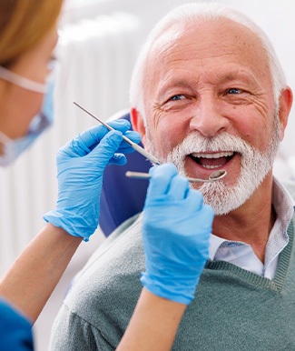 Man smiles at dentist