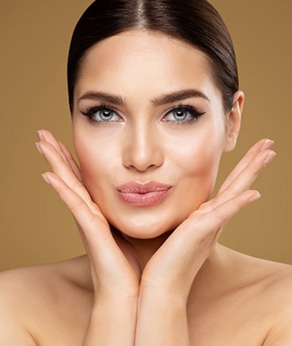 Woman with dermal fillers posing for the camera and touching her face