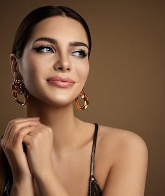 Elegant woman smiling on brown background