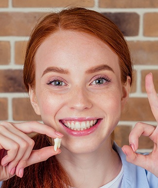 Woman holding a tooth